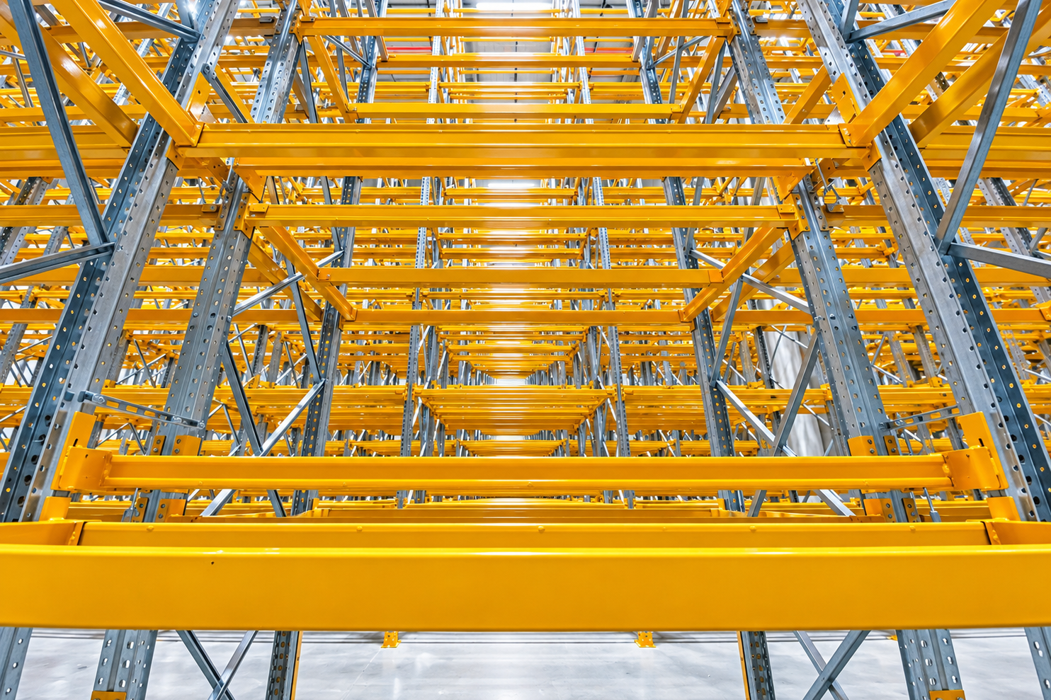 Industrial pallet racking system with multiple storage levels in a warehouse.